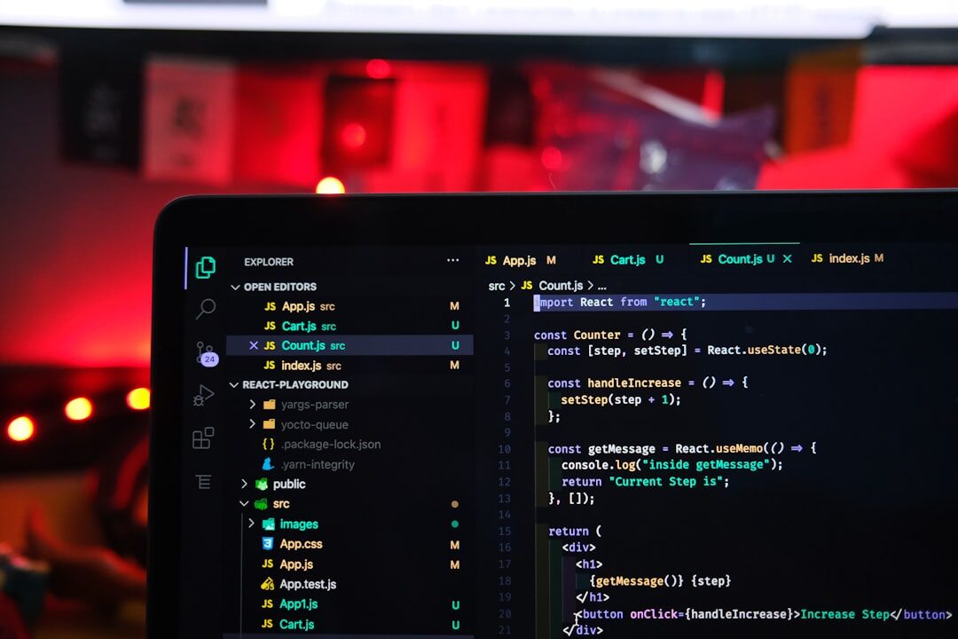 Software developer coding on multiple monitors with colorful code
